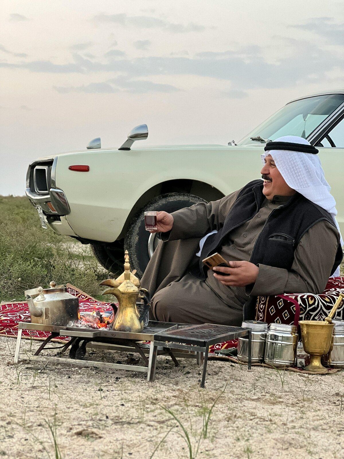 Outdoor community gathered around Arabic coffee